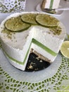 Lime cheesecake without baking. Decorated with lime slices. The piece is cut off. Lies on a plate Royalty Free Stock Photo