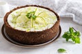 Lime cheesecake with peppermint. Cheesecake with cup of coffee on white background. Side view. Coffee house, confectionery concept Royalty Free Stock Photo