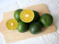a lime cut in half and placed on a cutting board Royalty Free Stock Photo