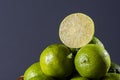 .Lime cut in half with some limes in the background on wooden table Royalty Free Stock Photo