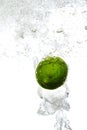 Lime is dropped into water Royalty Free Stock Photo