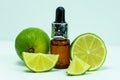 Lime essential oil. Bottles of lime essential oil on a white background. Royalty Free Stock Photo