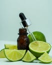 Lime essential oil. Bottles of lime essential oil on a white background. Royalty Free Stock Photo