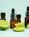 Lime essential oil. Bottles of lime essential oil on a white background. Fruit essence. Royalty Free Stock Photo