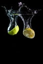 Lime fruit dropping in water Royalty Free Stock Photo