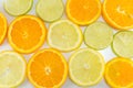 Lime fruit and orange slices making background Royalty Free Stock Photo