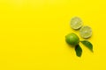 Lime fruits with green leaf and cut in half slice isolated on white background. Top view. Flat lay with copy space Royalty Free Stock Photo