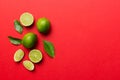 Lime fruits with green leaf and cut in half slice isolated on white background. Top view. Flat lay with copy space Royalty Free Stock Photo