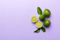 Lime fruits with green leaf and cut in half slice isolated on white background. Top view. Flat lay with copy space Royalty Free Stock Photo