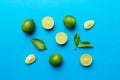 Lime fruits with green leaf and cut in half slice isolated on white background. Top view. Flat lay with copy space Royalty Free Stock Photo