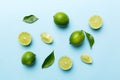 Lime fruits with green leaf and cut in half slice isolated on white background. Top view. Flat lay with copy space Royalty Free Stock Photo