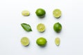 Lime fruits with green leaf and cut in half slice isolated on white background. Top view. Flat lay with copy space Royalty Free Stock Photo