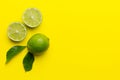 Lime fruits with green leaf and cut in half slice isolated on white background. Top view. Flat lay with copy space Royalty Free Stock Photo