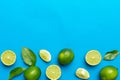 Lime fruits with green leaf and cut in half slice isolated on white background. Top view. Flat lay with copy space Royalty Free Stock Photo