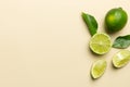 Lime fruits with green leaf and cut in half slice isolated on white background. Top view. Flat lay with copy space Royalty Free Stock Photo