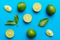 Lime fruits with green leaf and cut in half slice isolated on white background. Top view. Flat lay with copy space Royalty Free Stock Photo