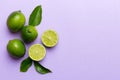 Lime fruits with green leaf and cut in half slice isolated on white background. Top view. Flat lay with copy space Royalty Free Stock Photo