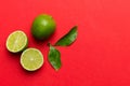 Lime fruits with green leaf and cut in half slice isolated on white background. Top view. Flat lay with copy space Royalty Free Stock Photo