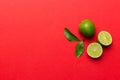 Lime fruits with green leaf and cut in half slice isolated on white background. Top view. Flat lay with copy space Royalty Free Stock Photo