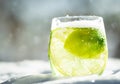 Lime in a glass with tonic