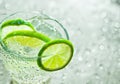 Lime in a glass with tonic