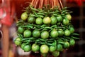 Lime and green chili peppers hanging outside an Indian store. Royalty Free Stock Photo