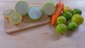 Lime and Green Winter Melon sliced half on wooden cutting board, carrot and fresh limes on the wooden floor Royalty Free Stock Photo