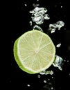 Lime (lemon) falling in water Royalty Free Stock Photo