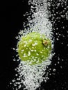 Lime (lemon) falling in water on black Royalty Free Stock Photo