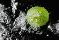 Lime (lemon) falling in water on black Royalty Free Stock Photo
