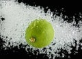 Lime (lemon) falling in water on black Royalty Free Stock Photo