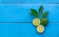 the Lime lemon are half cut on blue wooden background. copy space for graphic designer Royalty Free Stock Photo