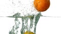 Lime lemon and orange plunging into water on white background