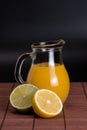 Lime, lemon and pitcher of juice Royalty Free Stock Photo