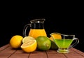 Lime, lemon and pitcher of juice Royalty Free Stock Photo