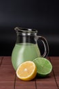 Lime, lemon and pitcher of juice Royalty Free Stock Photo