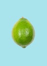 Lime levitate in air on blue background. Concept of fruit levitation
