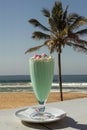 lime milkshake with palm tree and ocean