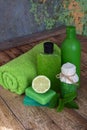 Lime mint composition beauty treatment products in green colors: shampoo, soap, bath salt, towel, oil. Various bath accessories. I Royalty Free Stock Photo