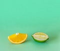 Lime and orange slices on a light green background. Exotic healthy fruit. Copy space for text Royalty Free Stock Photo