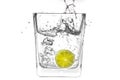 Lime slice falling in a glass of water Royalty Free Stock Photo