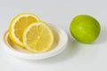 Lime and sliced lemons on a white background.