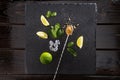 Lime slices with mint leaves and mix spoon on stone board