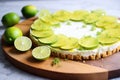 a lime tart with zested limes on a board Royalty Free Stock Photo