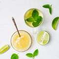 Lime tea with mint in a glass cup and honey on a white background Royalty Free Stock Photo