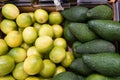 Limes and avocados at a farmers market Royalty Free Stock Photo