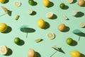Limes, lemons and cocktail umbrellas. Tropical summer background