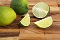 Limes and lime slices on a wooden pad