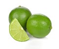 Limes with slices and leaves isolated on white background.