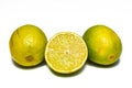 Limes on white background. Two limes and a half of a lime Royalty Free Stock Photo